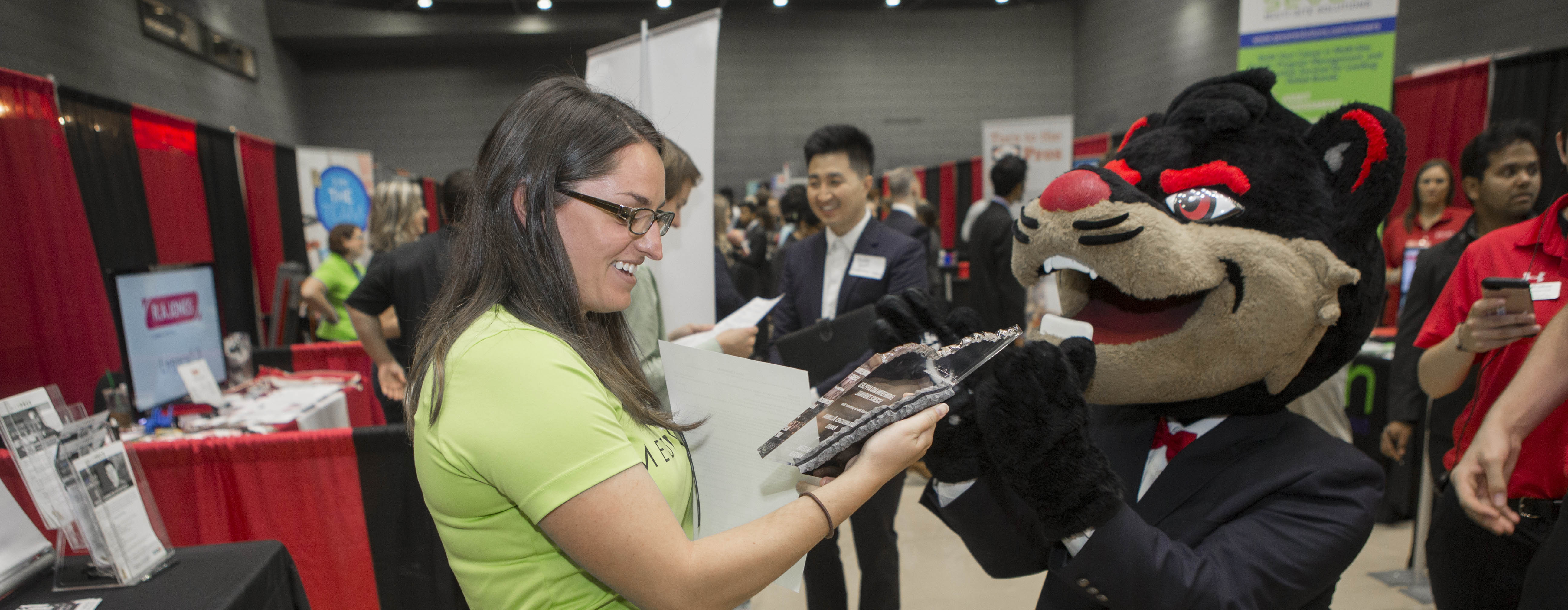 The Bearcat talking to an employer at the Career Fair.